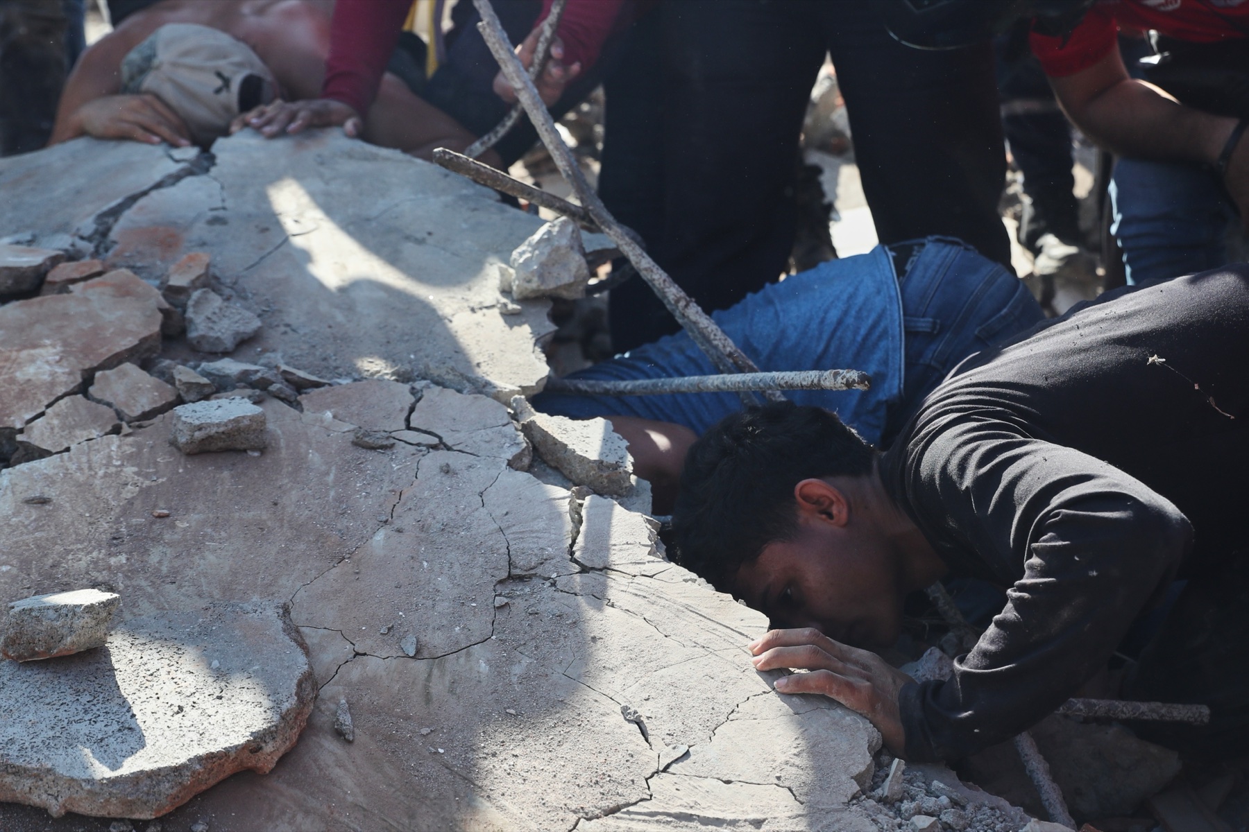 Residents and rescue workers search through earthquake rubble in Colombia.